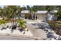 Inviting single-story home featuring well-maintained landscaping, a light grey exterior, and a spacious driveway at 8347 41St N Ave, St Petersburg, FL 33709
