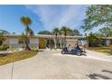 Charming single-story home with a well-manicured lawn, a bright yellow front door, and a private golf cart at 8347 41St N Ave, St Petersburg, FL 33709
