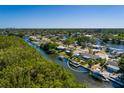 Aerial view of waterfront home with dock, lush landscaping, and serene canal setting at 9301 Sun Isle Ne Dr, St Petersburg, FL 33702