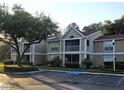 Exterior view of a tan two-story condo building with a handicap parking spot in the front at 9481 Highland Oak Dr # 1003, Tampa, FL 33647