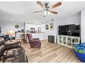 Open-concept living room with ceiling fan and vinyl flooring, seamlessly connected to the kitchen at 10028 Strafford Oak Ct # 712, Tampa, FL 33624