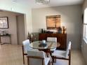 Bright dining area with modern round table, four chairs, and stylish accent cabinet at 101 Madonna Blvd, St Petersburg, FL 33715