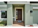 Inviting entryway featuring a covered porch and a well-lit, stylish front door at 11804 Harpswell Dr, Riverview, FL 33579
