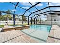 Relaxing screened-in pool with a spa and deck is perfect for entertaining or enjoying a quiet swim at 11804 Harpswell Dr, Riverview, FL 33579