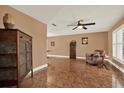 Inviting living room with tile floors, ceiling fan, and neutral paint, perfect for relaxation at 12467 93Rd Ave, Seminole, FL 33772