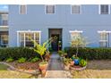 Charming entryway with a variety of potted plants and a decorative wreath on the door at 12805 Kings Crossing Dr, Gibsonton, FL 33534