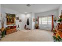 Bright living room with a comfortable seating area, front door, and natural lighting at 12805 Kings Crossing Dr, Gibsonton, FL 33534