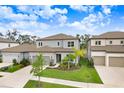 An elevated view of two-story homes with well-maintained yards on a street with healthy and mature landscaping at 14184 Samoa Hill Ct, Riverview, FL 33569