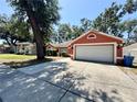 Single-story home with an attached two-car garage, featuring a spacious driveway at 1813 Landside Dr, Valrico, FL 33594