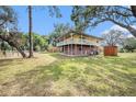 Spacious property with a charming two-story house featuring a wraparound porch at 18838 Huckavalle Rd, Odessa, FL 33556