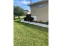 Well-maintained front yard with lush green grass and manicured landscaping surrounding the home at 2007 Acadia Greens Dr # 0, Sun City Center, FL 33573