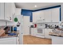 Bright kitchen featuring white cabinets, granite countertops, tile flooring, and modern appliances at 2007 Acadia Greens Dr # 0, Sun City Center, FL 33573