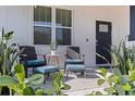 Inviting front porch featuring comfortable seating, a stylish rug, and lush greenery for a relaxing outdoor experience at 2150 43Rd N Ter, St Petersburg, FL 33714