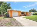 Single-story home featuring a garage, well-kept lawn, and a sunny disposition at 3065 Merrill Ave, Clearwater, FL 33759