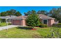 A single-story home featuring a 2-car garage, well-kept lawn, and mature trees at 3212 55Th E St, Palmetto, FL 34221