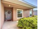 A welcoming front entrance features a gray door with a wreath and lush green landscaping at 3212 55Th E St, Palmetto, FL 34221