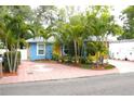 Charming blue home featuring well-manicured landscaping and a bright yellow door at 3306 E Chelsea St, Tampa, FL 33610