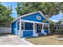 Stylish blue home with a white trim, a welcoming front porch, and fresh landscaping at 3706 N Ola Ave, Tampa, FL 33603