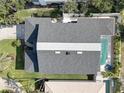 Aerial view of a private home featuring a dark roof, large swimming pool, and well-maintained landscaping at 413 8Th N Ave, Tierra Verde, FL 33715