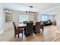 Elegant dining room with hardwood floors, modern light fixture, and stylish decor at 4231 8Th N St, St Petersburg, FL 33703