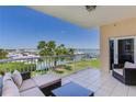 Relaxing balcony features cozy seating and overlooks scenic harbor views at 425 150Th Ave # 2301, Madeira Beach, FL 33708