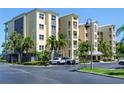 Beautiful condo exterior with lush tropical landscaping and ample parking at 425 150Th Ave # 2301, Madeira Beach, FL 33708