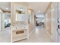 Inviting foyer with decorative console table, tile flooring, and open view to living spaces at 425 150Th Ave # 2301, Madeira Beach, FL 33708