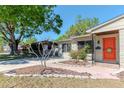 Charming home with lush landscaping, showcasing the walkway leading to the eye-catching front entrance at 4425 W Bay Villa Ave, Tampa, FL 33611