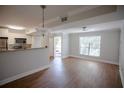 Open living area with wood floors, a ceiling fan, and easy kitchen access at 455 Alt 19 S # 235, Palm Harbor, FL 34683