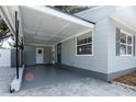 Attached carport featuring neutral colors, a side door, and access to the main house at 551 84Th N Ave, St Petersburg, FL 33702