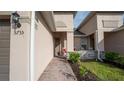 Charming front porch with stone accents, featuring two inviting rocking chairs and a wreath at 5735 Mezzana Run, Palmetto, FL 34221