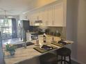 Eat-in kitchen featuring a breakfast bar with stools and stainless steel appliances at 7941 Clarendon Dr, New Port Richey, FL 34654