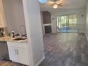 Open floor plan with modern flooring and fireplace at 7941 Clarendon Dr, New Port Richey, FL 34654