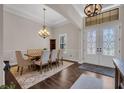 Formal dining area featuring an elegant chandelier, high ceilings, and decorative wainscoting at 803 Floresta St, Brandon, FL 33511