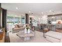 Open-concept living and kitchen area with hardwood floors, neutral decor and lots of natural light at 10537 Longmeadow Ave, Parrish, FL 34219