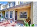 Inviting front porch area with a colorful rug and decorative touches at 10928 Brickside Ct, Riverview, FL 33579