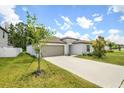 Well-maintained single-Gathering home with a two-car garage and landscaped front yard at 13419 Willow Bluestar Loop, Riverview, FL 33579