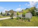 Inviting home with a two-car garage, complemented by a green lawn and sunny skies at 13419 Willow Bluestar Loop, Riverview, FL 33579