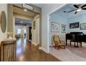 Inviting entryway with wood floors flowing into a living area and a separate home office at 14975 Renaissance Ave, Odessa, FL 33556