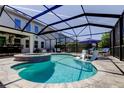 Beautiful screened-in pool area with inviting lounge chairs and a relaxing spa at 14975 Renaissance Ave, Odessa, FL 33556