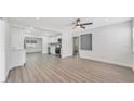 Spacious living area with sleek flooring, open floor plan, and view into the modern kitchen at 1625 Fulton Ave, Clearwater, FL 33755