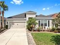 Charming single-Gathering home showcasing a well-manicured lawn and lovely landscaping at 17529 Buckingham Garden Dr, Lithia, FL 33547