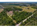 Large property featuring land partially covered with trees and neighboring open land at 18202 Bledsoe Loop, Lithia, FL 33547