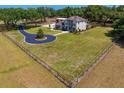 Expansive property featuring a well-maintained lawn, a circular driveway, and mature trees at 18202 Bledsoe Loop, Lithia, FL 33547