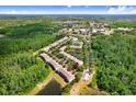 Aerial view of the townhome community surrounded by lush green spaces and a pond at 19281 Stone Hedge Dr, Tampa, FL 33647