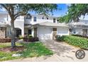 Inviting townhome with well-manicured lawn, stone accents, and a two-car garage at 19281 Stone Hedge Dr, Tampa, FL 33647