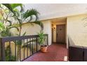 Welcoming condo entrance featuring a red brick floor, neutral walls, and a decorative front door with unit number 304 at 1935 Gulf Of Mexico Dr # G7-304, Longboat Key, FL 34228