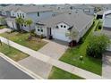 Aerial view of a well-maintained home featuring manicured landscaping and a two-car garage in a residential neighborhood at 2477 Water Willow Dr, Lutz, FL 33558