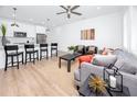 Comfortable living room with wood floors, ceiling fan, and an open kitchen with bar seating at 3402 E 28Th Ave # 6, Tampa, FL 33605