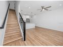 Open-concept living room showcases modern design with wood floors, a ceiling fan, and an adjacent kitchen area at 3402 E 28Th Ave # 6, Tampa, FL 33605